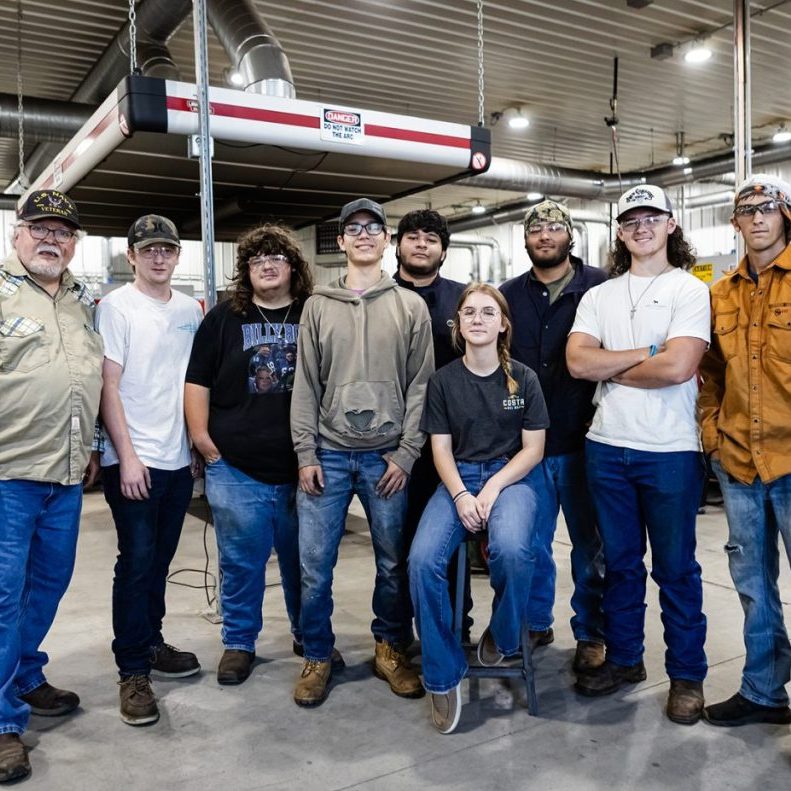 The Harrodsburg Herald/Robert Moore Members of the CU Harrodsburg welding class are retrofitting six vehicles in a project to feed hungry children in Central Kentucky. From left: Instructor Jim Lamirande, Howard Smith, John Thomas Roberts, Michael Ridge, Jashie Martinez, Diego Martinez, Kendall Boggess, Zane Ison and Bailey Marshall.